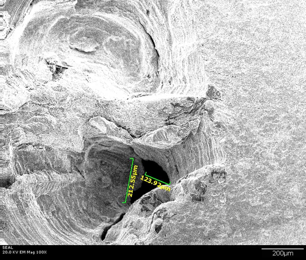 Close up of SEAL's Electron Microscope image of gas line hole caused by handyman's drill.